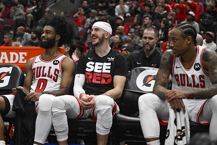 Chicago Bulls guard Coby White (0), guard Alex Caruso (6) and forward DeMar DeRozan (11) laugh on the bench a